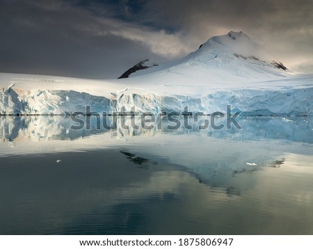 aerial view to harbor in calm morning with huge snow peak under clouds with copy space