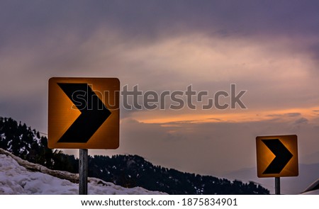 road safety sign with mountain and beautiful tinted sky
