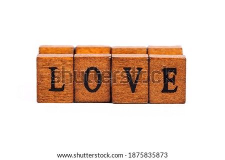 Word LOVE isolated, wooden letter  rubber stamps font closeup, on white, cut out. Simple love concept text element, letters up close, copy space, retro type, letterpress tiles typography style concept