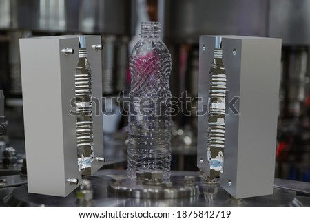 Mould of PET plastic bottles drinking water container on bottle blowing machine background Royalty-Free Stock Photo #1875842719