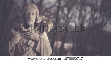 Ancient statue of Jesus Christ Good Shepherd. Free copy space for design.. 