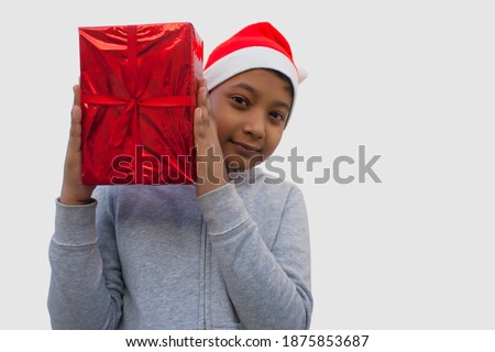 Happy young boy holding Christmas gift