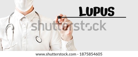 Doctor writing word LUPUS with marker, Medical concept