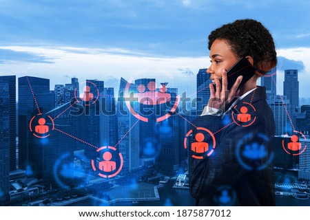 Attractive black cybersecurity developer explores new approaches to protect clients confidential information using phone. social media icons over Singapore city background.