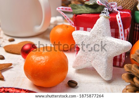 sweet food top view background for merry christmas or new year holiday decoration - chocolate candies, tangerines, cookies on white wood