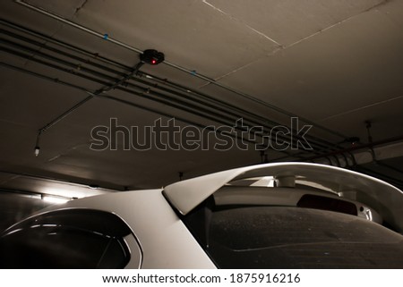 Smart parking guidance in department store with light overhead. Car lot.