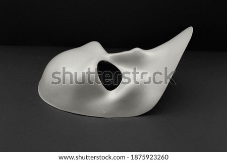 white carnival mask isolated on black background