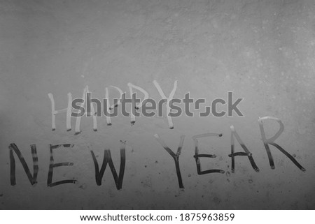 Happy New Year 2021 text written on the glass of window