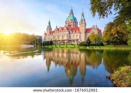 Hanover, Germany. Building of New Town Hall reflecting in water on sunset (HDR-image) Royalty-Free Stock Photo #1876052881