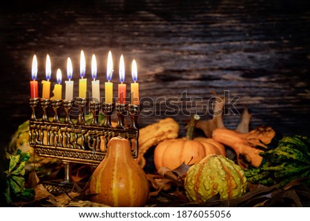 Kwanzaa holiday with decorate candles and pumpkin on wooden desk background