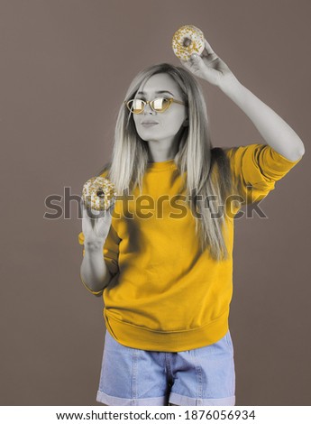 Portrait in duotone colors of woman with donuts