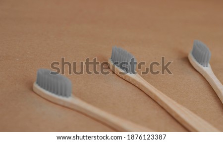 Bamboo toothbrushes in trendy ultimate gray color on craft paper. 