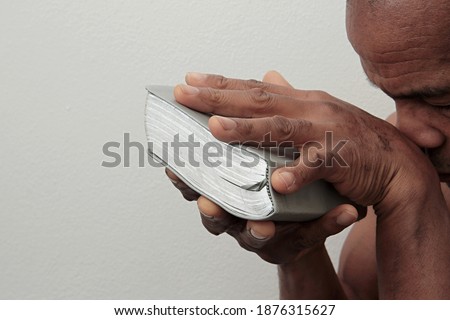 man praying to god with hands on bible praying with white background stock image stock photo