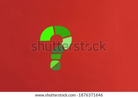 A question mark made up of green pieces on a red background. Clarification of the situation. Dialogue. Problem solving.