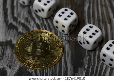 Bitcoin on black pine boards. Dice are scattered nearby.