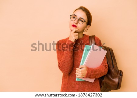 Young skinny arab student woman looking sideways with doubtful and skeptical expression. Royalty-Free Stock Photo #1876427302