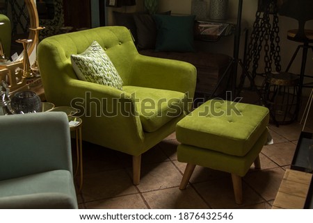 Vintage green armchair with footstool Royalty-Free Stock Photo #1876432546