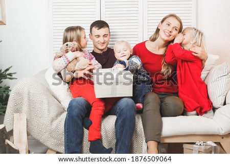 Happy Christmas Family with Kids opening Gift