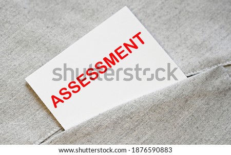 ASSESSMENT text on the white sticker in the shirt pocket.