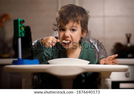 little boy with autism eats porridge