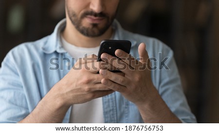 Wide banner close up view of young Caucasian man use modern smartphone text or message online. Male client or customer browse surf wireless internet on cellphone gadget. Communication concept.
