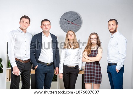 Smiling employees standing looking at camera making team picture in office together. Business People Team. Successful company with happy workers.