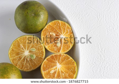 Fresh orange on the white plate in copy space