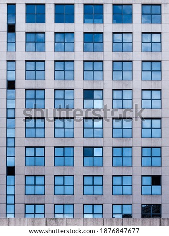 A vertical shot of a windows pattern in a modern building acade