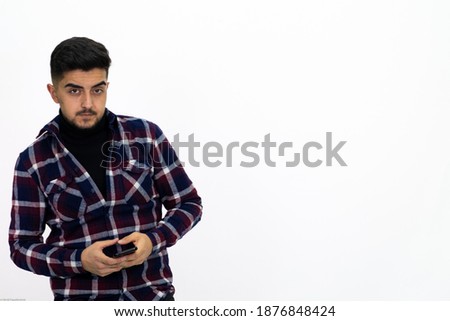 Young man wearing a checkered shirt. He's got a phone. Isolated White background.