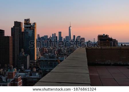 A view of the New York City skyline from a building's rooftop. High quality photo