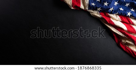 Martin Luther King Day anniversary concept. American flag against black wooden background