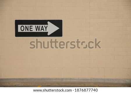 One Way sign on a wall