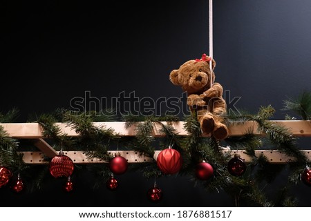 Cute teddy bear with blurred Christmas, blackboard for your text. retro style toned picture with sample text Merry Christmas.