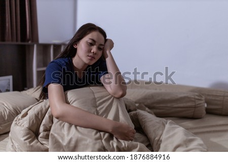 Young asian woman cannot sleep insomnia late at night. Can't sleep. Sleep apnea or stress. Sleep disorder concept. Royalty-Free Stock Photo #1876884916