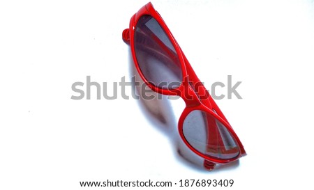 Red glasses for childern, made of plastic, used for fhasion