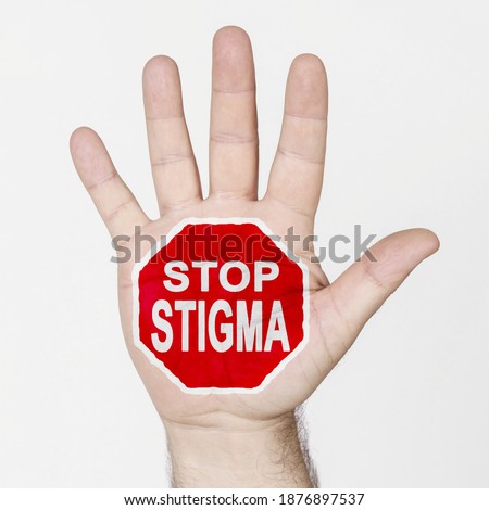 Medicine concept. On the palm of the hand there is a stop sign with the inscription - STOP STIGMA. Isolated on white background.
