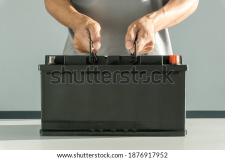 Auto mechanic holding car battery, Technician replacing car battery, Cconcept car inspection, maintenance, checking
 Royalty-Free Stock Photo #1876917952