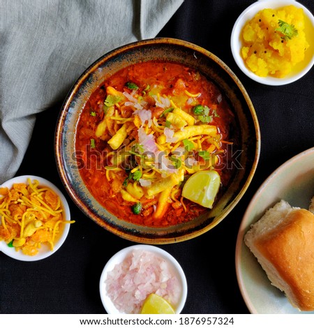 misal pav - maharastrian dish, spicy street food Royalty-Free Stock Photo #1876957324