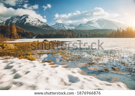 Winter landscape of a frozen mountain lake on a frosty sunny day. Location place Strbske pleso, High Tatras national park, Slovakia, Europe. Vibrant photo wallpaper. Discover the beauty of earth.