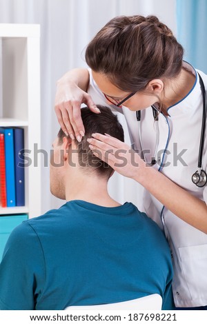 Young female doctor examining patient in the office 