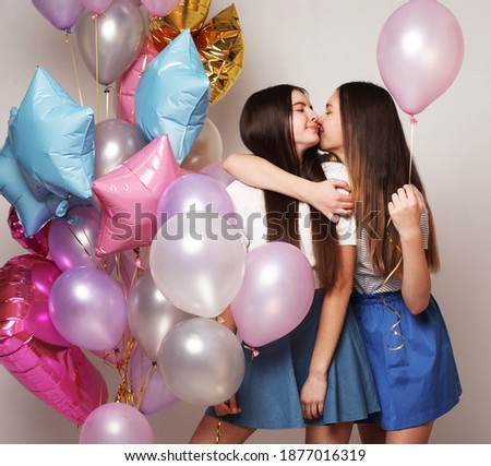 lifestyle and people concept: two girls friends with colorfoul air balloons