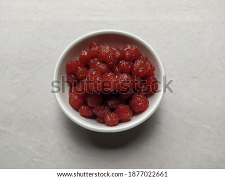 very tasty and healthy Indian gooseberry candy in a white bowl on a white background with space for gradient text