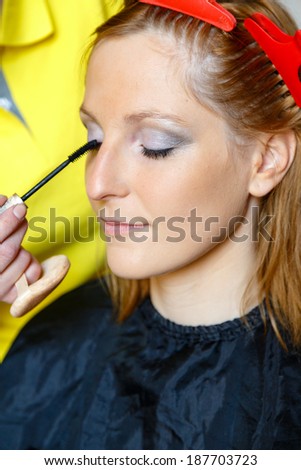 Woman having her hair and make up done for photo shooting