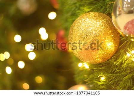 Close up of balls on christmas tree. Bokeh garlands in the background. New Year concept.