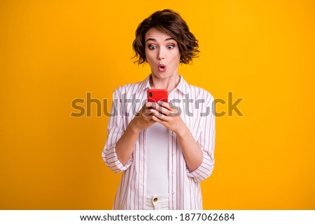 Photo of astonished girl use smartphone impressed social media information wear good look clothes isolated over bright shine color background