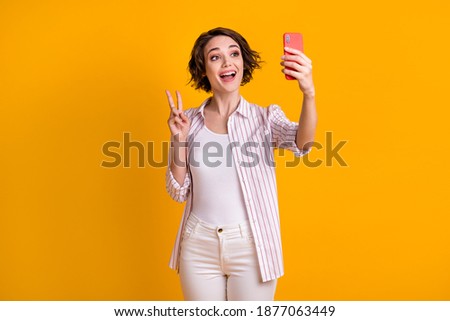 Photo of positive cheerful girl take selfie photo enjoy summer travel trip make v-sign wear white pants trousers isolated over bright color background