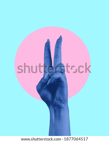 Contemporary art collage. Blue human hand showing victory sign.
