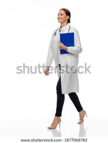 medicine, profession and healthcare concept - happy smiling female doctor in white coat with stethoscope and clipboard walking with clipboard Royalty-Free Stock Photo #1877068783