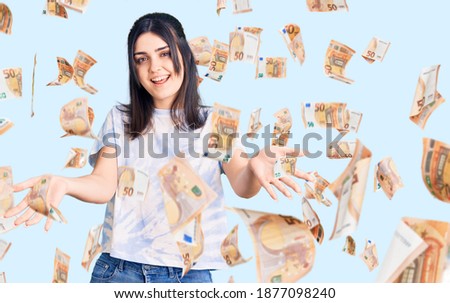 Young beautiful girl wearing casual t shirt smiling cheerful offering hands giving assistance and acceptance.
