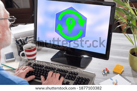 Man using a computer with renewable energy concept on the screen